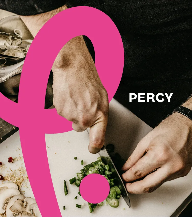 Chef slicing fresh chillies on a prep bench in a professional kitchen